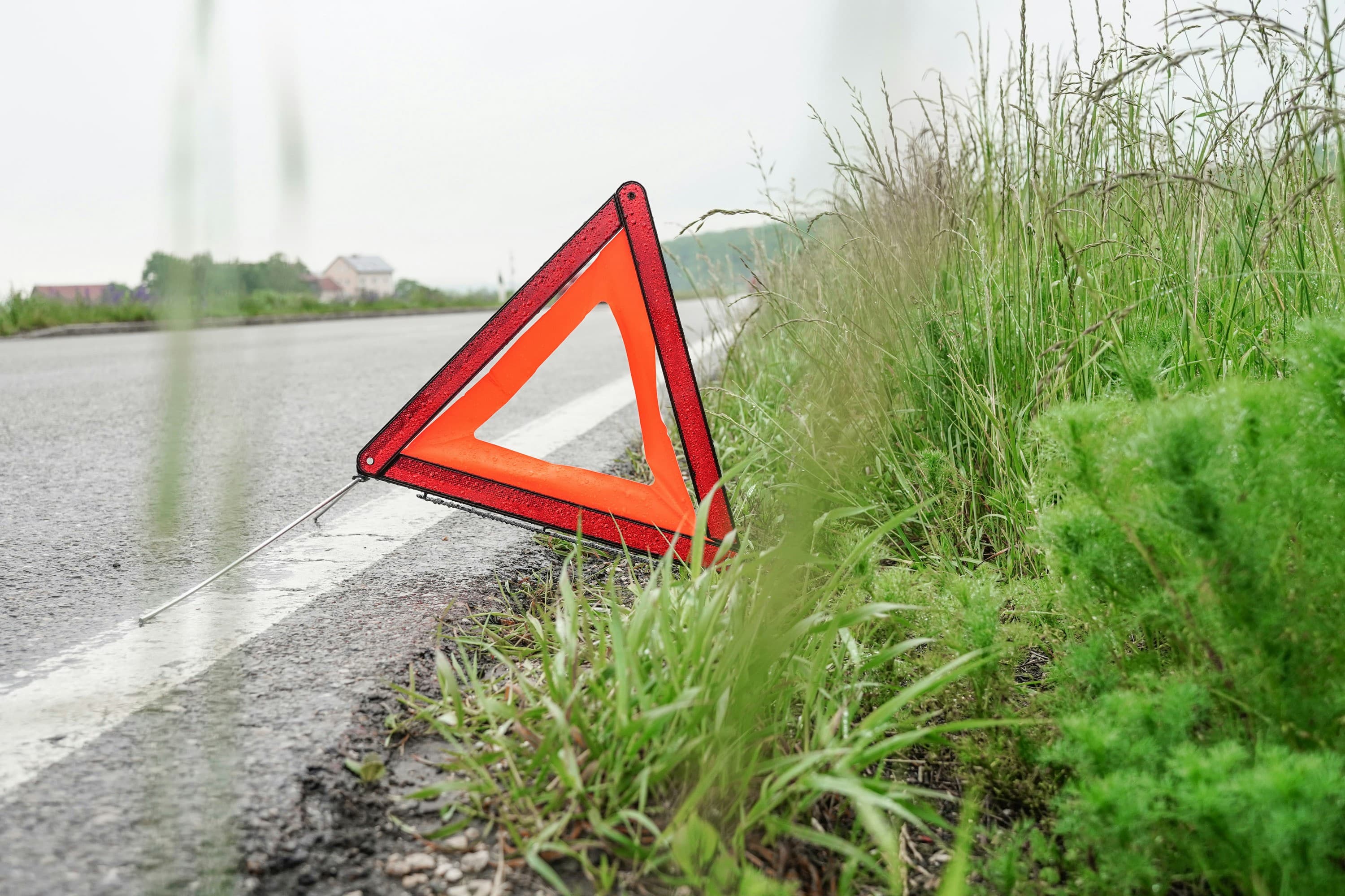 Red warning triangle set out at the side of a road